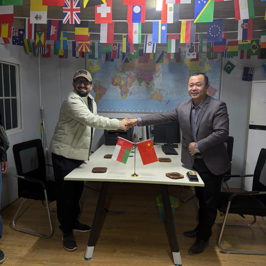 Handshake between 4U Business Links and a supplier, Oman and China flags on the table